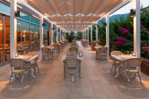a restaurant with tables and chairs on a patio at Elite World Marmaris - Adult Only in Marmaris