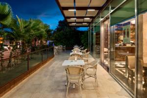 a row of tables and chairs on the balcony of a restaurant at Elite World Marmaris - Adult Only in Marmaris