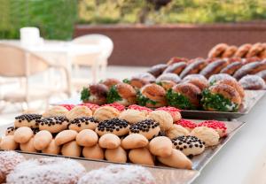 a display of different types of donuts on a table at Elite World Marmaris - Adult Only in Marmaris
