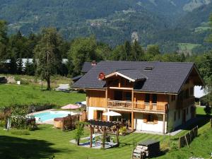 an image of a house with a swimming pool at La Terrasse - 3 bedrooms with private Hot Tub in Samoëns