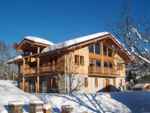 a large wooden house with snow on the roof at La Terrasse - 3 bedrooms with private Hot Tub in Samoëns