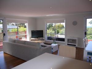 a living room with a couch and a television at Prime Location - Totally Refurbished in Bridport