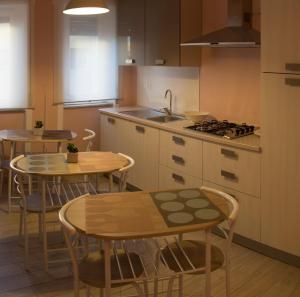 a kitchen with two tables and a sink and a stove at B&B Rosa in Cosenza