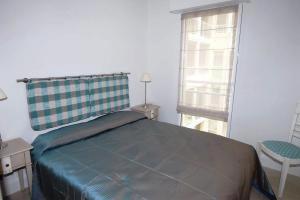 a bedroom with a bed and a window at Stunning 2 Bed, 2 Bath Apt on the Cannes sea front has swimming pool and is a secure modern building 464 in Cannes +6 photos