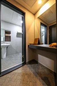 a bathroom with a shower and a sink at Bcent hotel in Busan