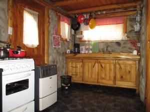 a kitchen with a stove and a white stove top oven at Paraiso Bariloche in San Carlos de Bariloche