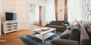 a living room with a couch and a coffee table at Helvetia Suites in Düsseldorf