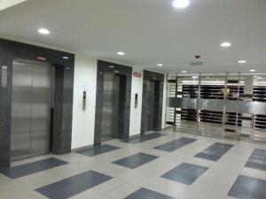 a lobby with many elevators in a building at Hello Kitty Signature Suite in Sandakan