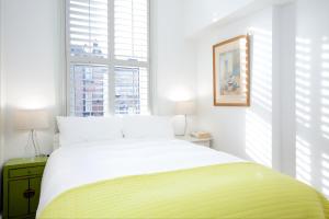 a bedroom with a large bed and a window at Retro apartment moments from Battersea Park in London