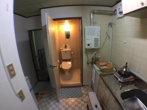 a small bathroom with a toilet and a sink at Kenroku Haitsu 302 in Kanazawa