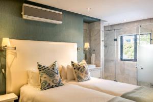 a bedroom with a large bed and a shower at Lions Eye Luxury Apartments in Cape Town