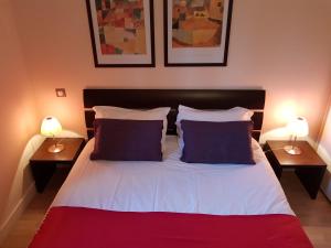 a bedroom with a large bed with two lamps at Mas de Valrugues Holifrance in Saint-Rémy-de-Provence