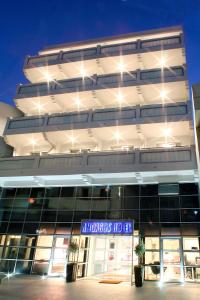 a large building with a sign in front of it at Amorgos Boutique Hotel in Larnaka