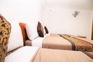 Postel nebo postele na pokoji v ubytování Phu Tho Da Lat Hotel