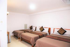 Postel nebo postele na pokoji v ubytování Phu Tho Da Lat Hotel