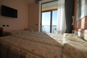 a bedroom with a bed with a view of the ocean at Hotel San Terenzo in Lerici