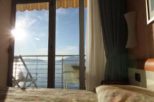 a bedroom with a window with a view of the ocean at Hotel San Terenzo in Lerici