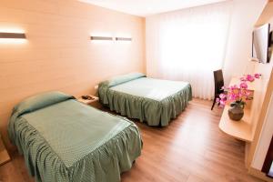 A bed or beds in a room at Al Benvenuto Hotel & Restaurant