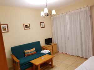 Telewizja i/lub zestaw kina domowego w obiekcie Apartamentos Olympia Garden