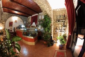 a room with a bar with plants in it at Nerodivino B&B in Torchiara