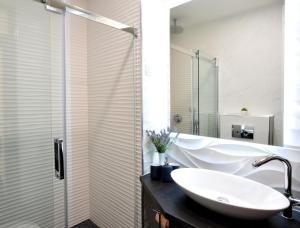 a bathroom with a sink and a shower at Libertas Zagreb centre view in Zagreb