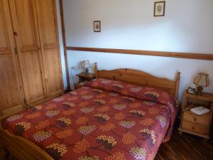 Łóżko lub łóżka w pokoju w obiekcie Residence Casa Canazei