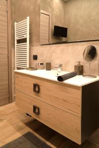 a bathroom with a sink with a lamp and a mirror at Sforza Apartment Near Duomo in Milan
