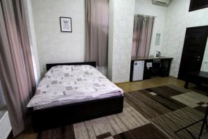 a bedroom with a bed and a dresser in it at Apelsin apartment in Bila Tserkva