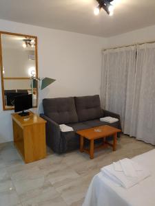 salon z kanapą i stołem w obiekcie Apartamentos Olympia Garden w mieście La Manga del Mar Menor