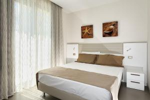 Postel nebo postele na pokoji v ubytování Hotel & Residence Cavalluccio Marino