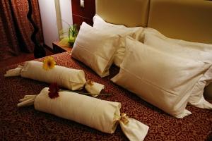 a group of white pillows sitting on a table at Siris Hotel in Serres +16 photos