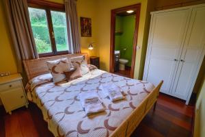 a bedroom with a bed with two books on it at La Casina de Punticiella in El Pito