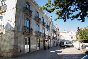 un edificio con balcones al lado de una calle en São Filipe Alojamento en Setúbal