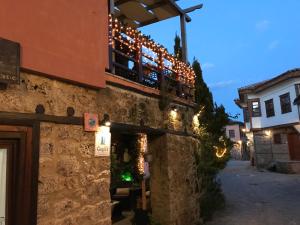 a building with christmas lights on the side of it at Varosi Guesthouse in Edessa