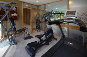 a gym with several exercise bikes and a laptop at Hostería Huenú in Villa La Angostura