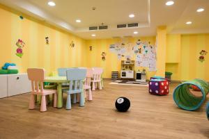 a living room filled with furniture and toys at Alimounda Mare Hotel in Karpathos Town