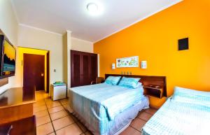 Cama ou camas em um quarto em Pousada Villa Di Rimini