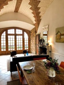 a living room with a table and a couch at Domaine de Vauluisant in Courgenay