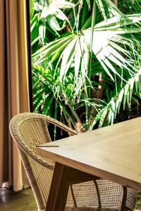 a wooden table and chairs with plants in the background at Azul Singular in Horta
