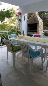 a table and chairs with a fireplace in a patio at Villa Anja in Kusadası