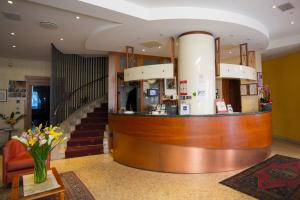 a lobby with a counter and a staircase at Hotel Brennero in Bassano del Grappa