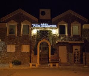 a building with a sign that reads villaellez at Villa Edelweiss in Sveti Stefan