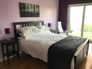a bedroom with a large bed and a window at Mick's Cottage in Loughrea
