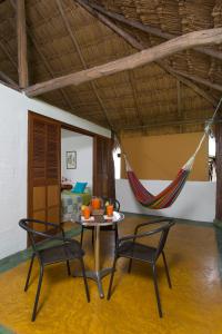 a room with a table and two chairs and a hammock at Hotel Cinaruco Caney in Villavicencio