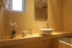 a bathroom with a bowl sink on a counter at Villa Mangano in Afantou +29 photos