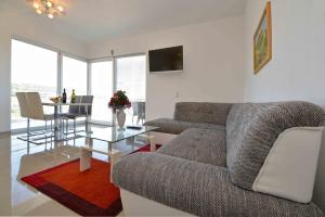 a living room with a couch and a table at Apartments Bilanovic in Tisno