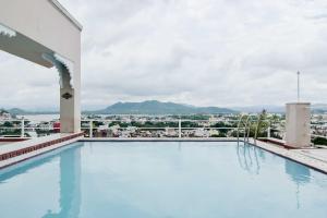 a swimming pool on the roof of a building with a view at Hotel Raj Kuber in Udaipur