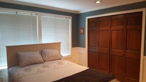 a bedroom with a bed and a large closet at Villa Rivarola in Edmonds