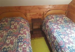two beds sitting next to each other in a room at Casona Familiar Pucon Centro in Pucón