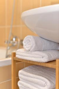 a pile of towels on a shelf in a bathroom at Deak Apartment in Budapest